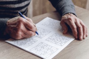 Saying Under a Senior's Headshot Crossword