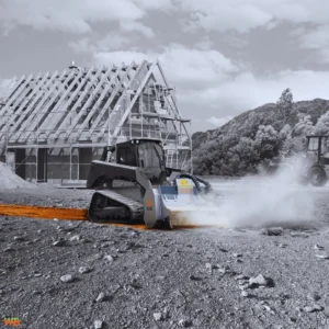 Optimizing Construction Projects with Skid Steer Rock Crushers A white tracked loader equipped with FAE Skid Steer Rock Crushers processing gravel and soil at a residential construction site.