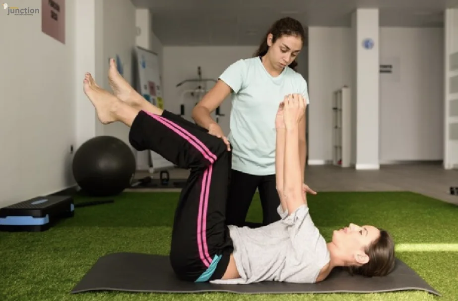 Physiotherapy session: A therapist assists a patient with leg and arm exercises for rehabilitation.