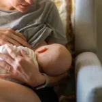 Mother breastfeeding her baby in a cozy environment, bonding and nurturing.