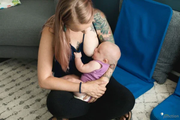 Mother breastfeeding her baby, enjoying a nurturing and bonding moment.