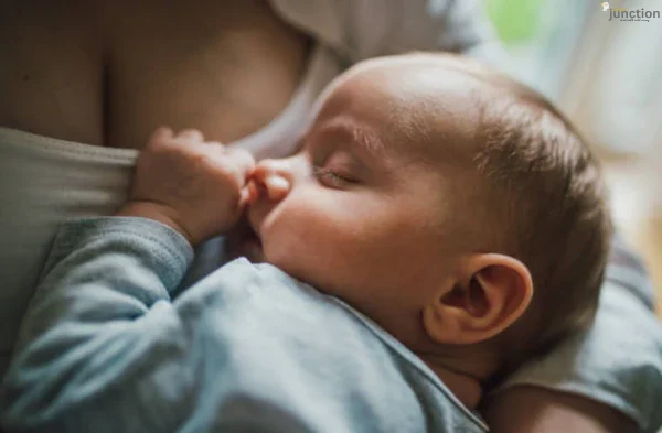 Baby peacefully breastfeeding, enjoying the comfort and nourishment from mother.