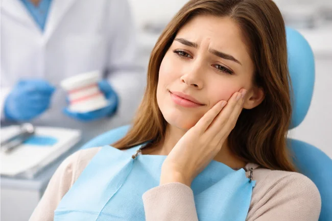 Deep Teeth Cleaning side effects showing patient experiencing mild jaw discomfort after treatment